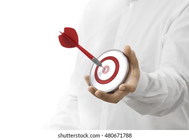 caucasian man holding a modern target with a dart in the center. image over white background. Concept of objective attainment.