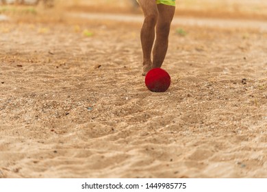 Caucasian man kicking soccer ball on sand beach at sunset - Powered by Shutterstock