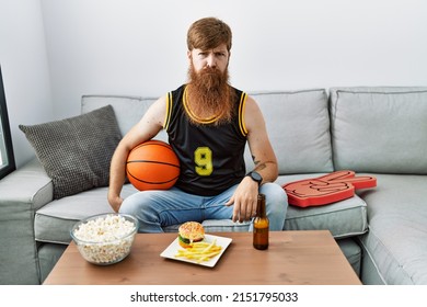 Caucasian Man With Long Beard Holding Basketball Ball Cheering Tv Game Depressed And Worry For Distress, Crying Angry And Afraid. Sad Expression. 