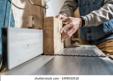 Caucasian man making wooden parts for custom furniture on machine tool called thickness planer in carpentry. Producing lumber concept - Shutterstock ID 1498920518