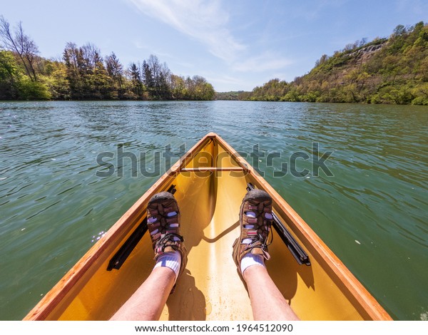 Stock photo of elderly feet inside a canoe being paddles down the river in Morgantown WV