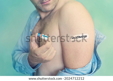 Caucasian man, patient with band-aid vaccinated on hand. Concept of people vaccination for covid-19 coronavirus, flu, infectious diseases. Injection. Mandatory mass vaccination of world's population