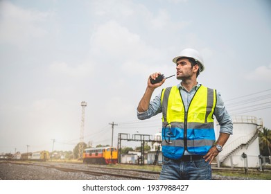 Caucasian man railway engineer use walkie-talkie talking in the site work of train garage. - Powered by Shutterstock