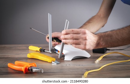 Caucasian Man Repairing Wifi Router.