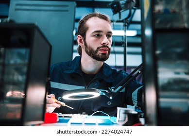 Caucasian man specialist robotic engineers maintenance on 
circuit board robotic controller in repair department, Testing new program on automatic robot machine. - Powered by Shutterstock - Get 15% off with code: PIKWIZARD15