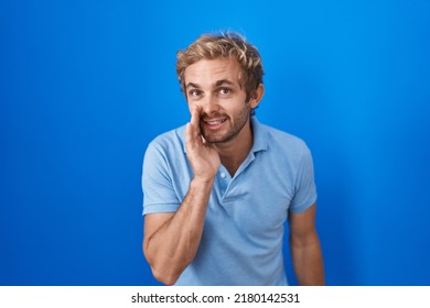 Caucasian Man Standing Over Blue Background Hand On Mouth Telling Secret Rumor, Whispering Malicious Talk Conversation 