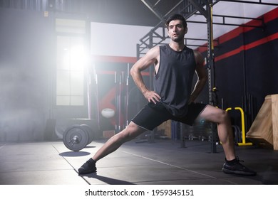 Caucasian Man Stretching  His Legs Before Workout in a Gym - Powered by Shutterstock