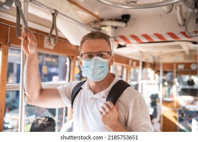 Caucasian Man Student On Face Medical Mask While Traveling Inside Public Transport, Tram Turkey.