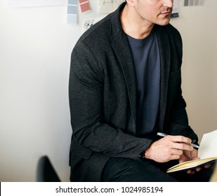 Caucasian man taking a note