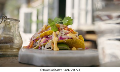 Caucasian Man Taking Taco Into His Hand. Beautiful And Bright Mexican Dish On A Exquisite Marbel Plate. Latin American Cuisine In A Cafe Outdoors.