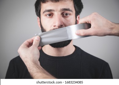 Caucasian Man With Tape On Mouth. Censorship