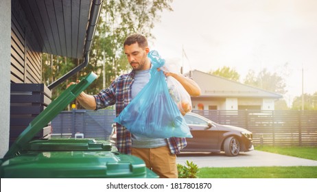 Caucasian Man is Throwing Away Two Plastic Bags of Trash next to His House. One Garbage Bag is Sorted with Biological Food Waste, Other with Recyclable Bottles Garbage Bin.