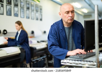 Caucasian Man Using Computer In Printing Office, Pushing Buttons On Keyboard.