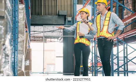 Caucasian Man, Woman Warehouse Supervisor Wear Safety Discuss,talk And Use Clipboard Check Box Package On Shelf, Product Distribution Inventory Management,Logistics Shipping Business Planning Industry