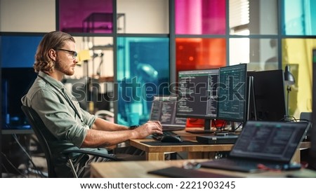 Caucasian Man Writes Code on Desktop Computer With Professional Multiple Monitors Setup in Modern Office. Male Data Scientist Using Software to Collect and Analyze Information From Opened Sources.