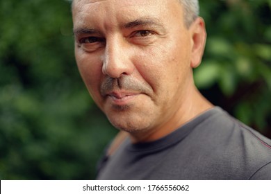 Caucasian Mature Man Close Up Portrait. Real People Authentic Lifestyle Portrait.