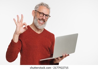 Caucasian Mature Middle-aged Freelancer Businessman Ceo Manager Using Laptop For Online Shopping, Remote Work, E-learning E-commerce Showing Okay Gesture Isolated In White