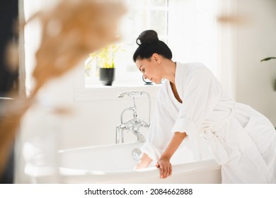 Caucasian Mature Middle-aged Woman Preparing For Taking Shower Bath In Spa Bathrobe At Home. Beautification On Resort Spa Concept