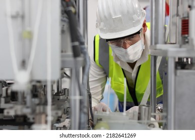 Caucasian Mechanic Technician Maintenance, Repairing Industrial Machinery Equipment In Factory. Professional Worker In Protective Clothing With Goggles And Mask Using Wrench At Manufacturing Factory