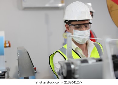 Caucasian Mechanic Technician Maintenance, Repairing Industrial Machinery Equipment In Factory. Professional Worker In Protective Clothing With Goggles And Mask Using Wrench At Manufacturing Factory