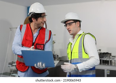 Caucasian Mechanic Technician Maintenance, Repairing Industrial Machinery Equipment In Factory. Professional Worker In Protective Clothing With Computer And Mask Using Wrench At Manufacturing Factory