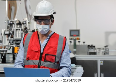 Caucasian Mechanic Technician Maintenance, Repairing Industrial Machinery Equipment In Factory. Professional Worker In Protective Clothing With Computer And Mask Using Wrench At Manufacturing Factory