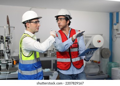 Caucasian Mechanic Technician Maintenance, Repairing Industrial Machinery Equipment In Factory. Professional Worker In Protective Clothing With Computer And Mask Using Wrench At Manufacturing Factory