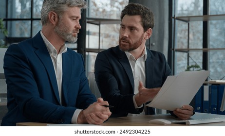 Caucasian men businessmen discussing agreement business documents in office dissatisfied leader employer disappointed with failed contract problem deal colleagues partners upset bad news tax penalty - Powered by Shutterstock