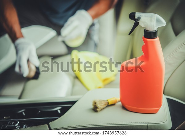 Caucasian Men\
Cleaning Vehicle Interior Using Specialized Sanitizing Detergent.\
Car Interior\
Maintenance.