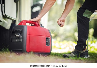 Caucasian Men Firing Portable Inverter Generator to Electrify RV Camper Van During Dry Camping. RV Boondocking with Own Small Electricity Gas Powered Plant. - Shutterstock ID 2157104155