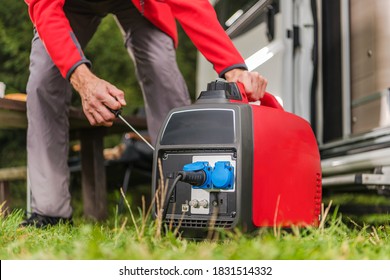 Caucasian Men in His 40s Firing Up Gas Powered Portable Inverter Generator To Connect Electricity To His Camper Van. 