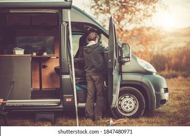 Caucasian Men In His 50s With Recreational Vehicle RV Class C Camper Van On A Camping. Travel And Van Life Theme.