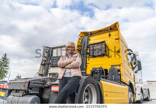 Caucasian mid age woman driving
truck. trucker female worker, transport industry occupation

