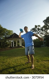 Caucasian Mid-adult Man Throwing Football.