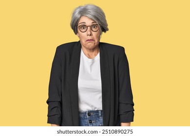 Caucasian mid-age female in business suit shrugs shoulders and open eyes confused. - Powered by Shutterstock