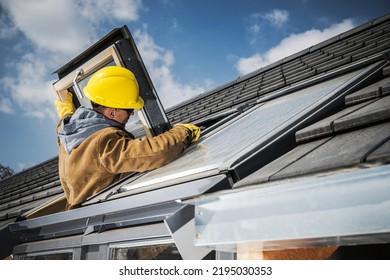 Caucasian Middle Aged Man In Yellow Hard Hat Checking And Fixing The Roof Window In Residential House. Professional Home Repair Services Theme.