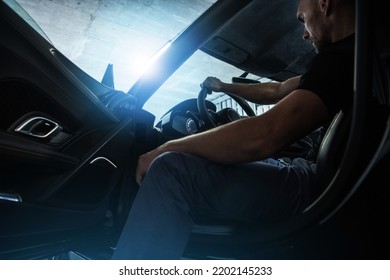 Caucasian Middle Aged Rich Man Sitting on a Driver's Seat in His Super Car Keeping Right Hand on the Steering Wheel and Getting Ready to Leave the Underground Garage.