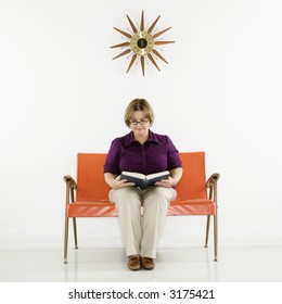 Caucasian Middle Aged Woman Sitting Reading Book.