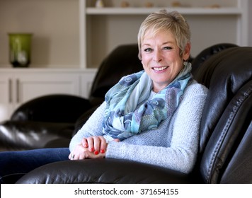 Caucasian Middle Aged Woman Sitting On Sofa At Home