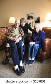 Caucasian Middle-aged Daughter With Elderly Parents In Retirement Community Center.