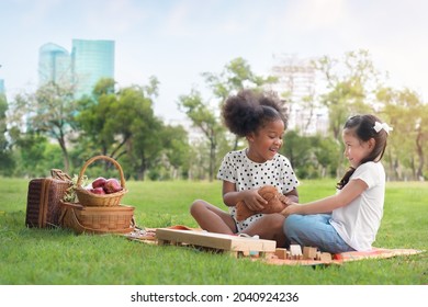 Caucasian Mix Girl And African Girl Play Teddy Bear Doll Together At  Outdoors Park, Picnic Time, Relationship Little Kids, Diverse Black And White Ethnic Concept