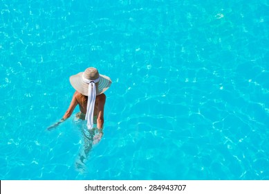 Caucasian model playing into clear water on summer vacation - Shutterstock ID 284943707