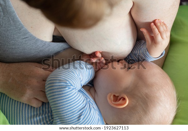 Caucasian mother breastfeeding a baby boy.\
Maternity love babycare family\
concept
