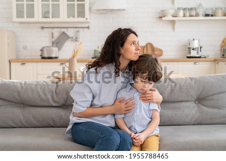 Caucasian mother feel sorry after fight and scold of preschool son hug him in comfort, love and care. Caring young mom showing support to unhappy offended kid. Family relationship crisis trust concept