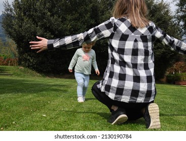 Caucasian Mother With Open Arms Waiting To Hug Her Little Daughter. Family, Daily Life, Mother's Day