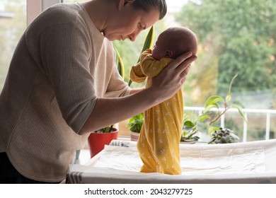 Caucasian Mother Testing Her Newborn Baby Reflex.