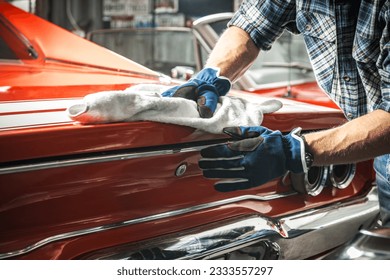 Caucasian Muscle Cars Enthusiast Taking Care of His Classic Cars Collection. Automotive Theme.