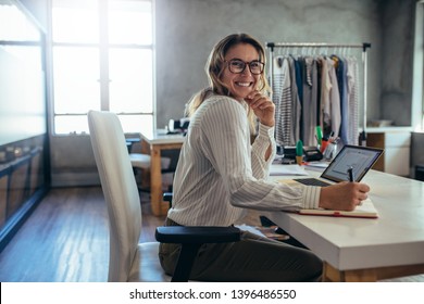 Caucasian online seller businesswoman working at office. Female entrepreneur taking online orders.