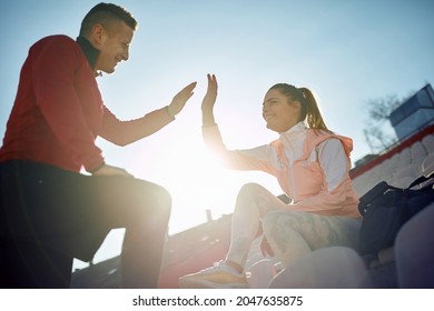 Caucasian Personal Male Trainer Giving High Five To Young Adult Female, Satisfied After Good Training