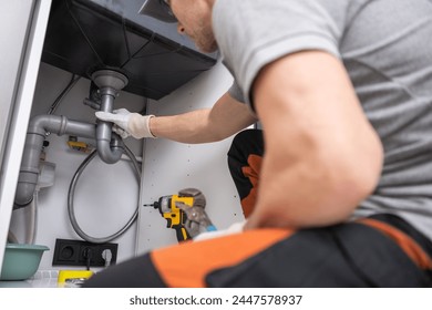 Caucasian Plumber Performing Quick Kitchen Sink Drain Fix